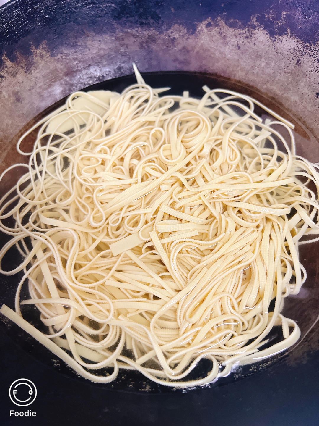 Scald the tofu shreds in boiling water with a