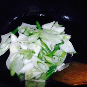 Hot pan, cool oil: add the scallion and cook