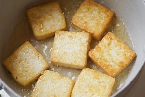 Sear the tofu golden on both sides