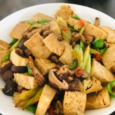 Golden frozen tofu braised with shiitake in a soy glaze