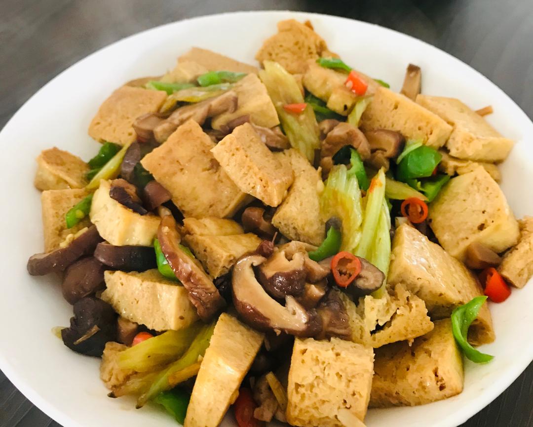 Golden frozen tofu braised with shiitake in a soy glaze