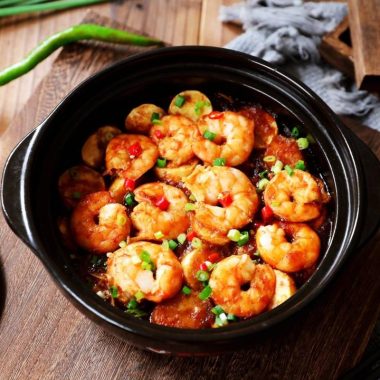 Golden tofu and shrimp layered in a tomato-glazed clay pot