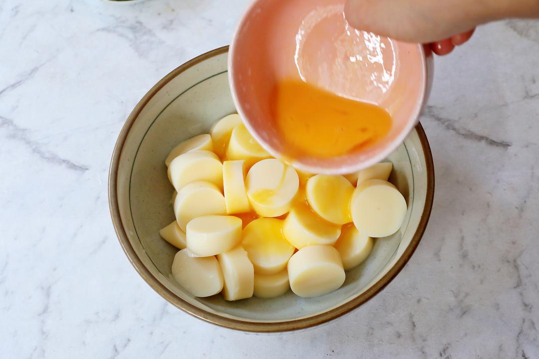 Coat the egg tofu slices in beaten egg