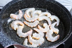In the same pan, sear the shrimp until they c