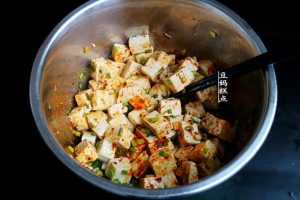 Mix the chili oil into the tofu