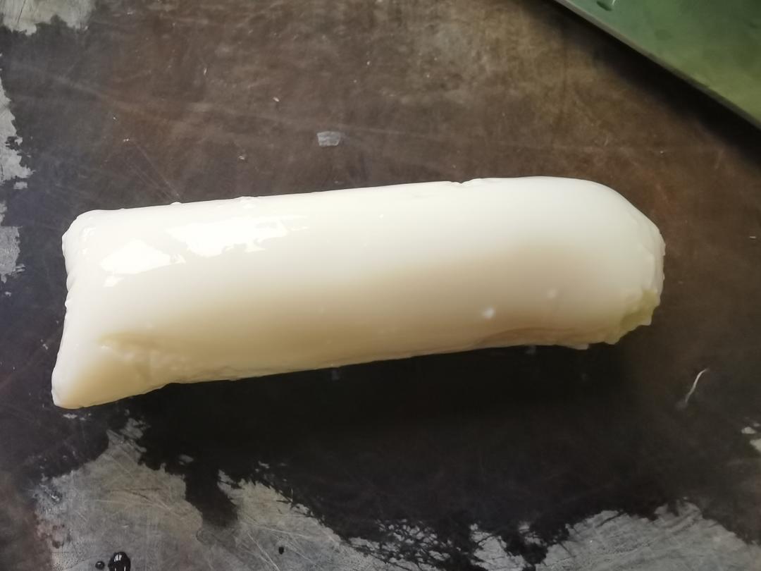 Cut open the tofu tube and ease the tofu out