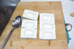 Hollow each piece with a spoon