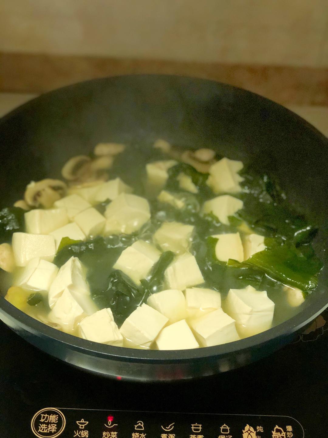 Add water and bring to a boil; add the tofu a