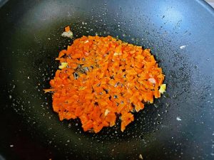 Stir-fry the carrot until it changes color
