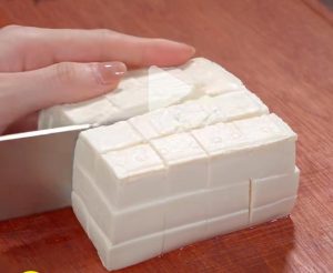 Prep the ingredients: cut the silken tofu sma