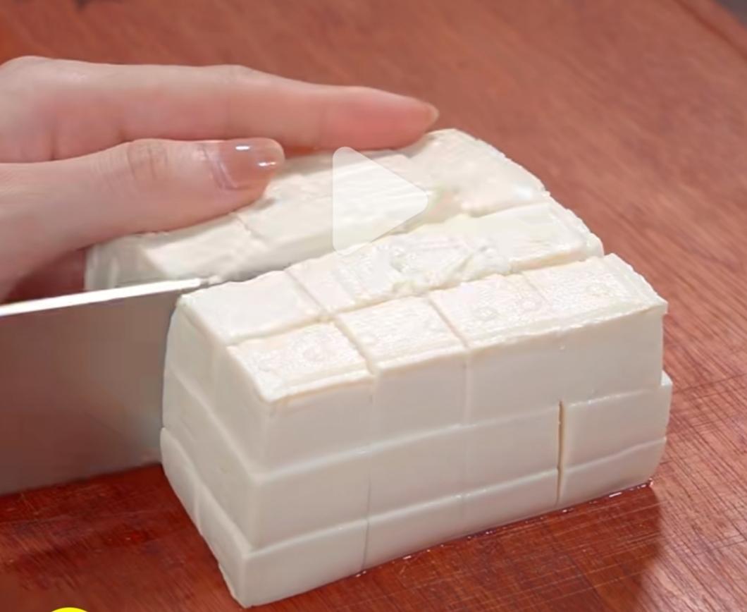 Prep the ingredients: cut the silken tofu sma