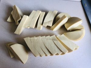 Halve it lengthwise, then cut into half-moon